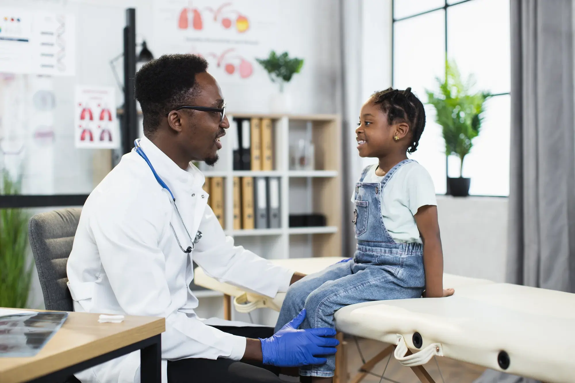 A doctor examining the health of a young girl at a clinic in Africa