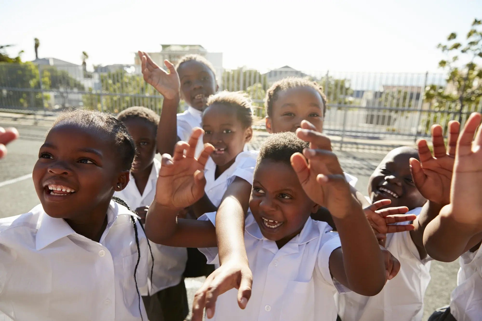 A smiling young woman gesturing openly, representing awareness and possibility